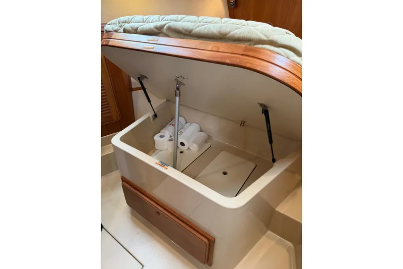  Yacht Photos Pics 2008 Island Packet SP Cruiser storage compartment with open lid and paper towels inside.