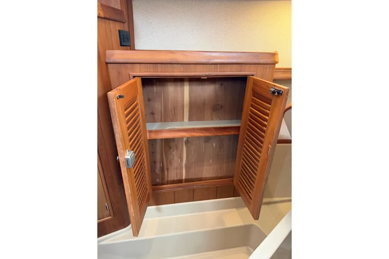  Yacht Photos Pics Open wooden cabinet on 2008 Island Packet SP Cruiser boat interior.