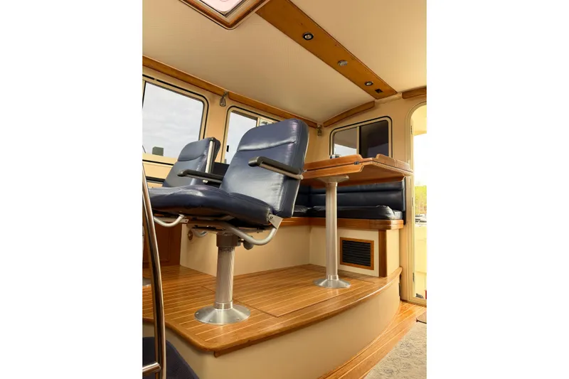  Yacht Photos Pics 2008 Island Packet SP Cruiser interior with blue seating and wooden flooring.