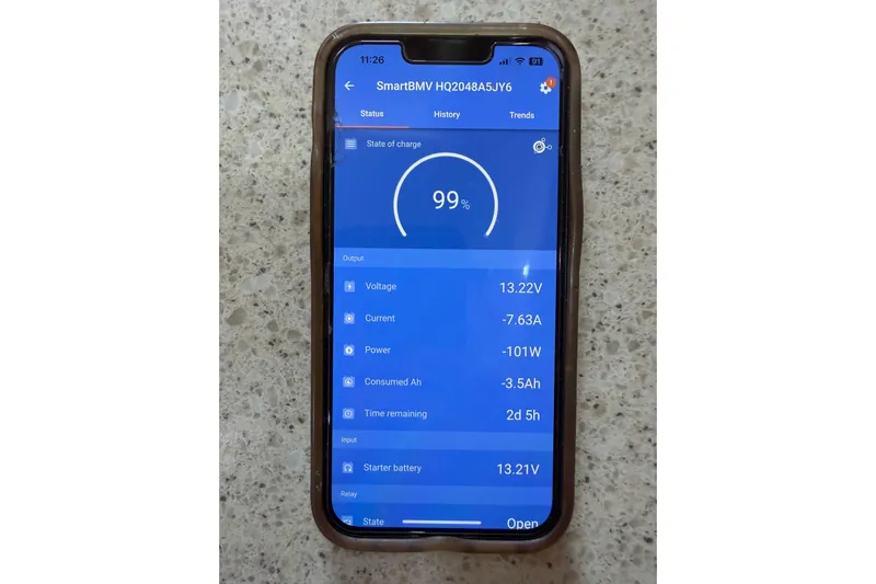  Yacht Photos Pics Smartphone displaying battery status app for Island Packet SP Cruiser 2008, showing 99% charge.