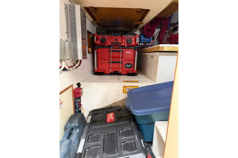  Yacht Photos Pics Storage area in a 2008 Island Packet SP Cruiser with organized toolboxes and equipment.