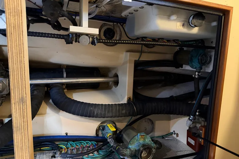  Yacht Photos Pics Engine compartment of a 2008 Island Packet SP Cruiser, showcasing mechanical components and hoses.