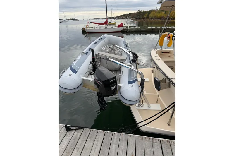  Yacht Photos Pics A 2008 Island Packet SP Cruiser with a dinghy and Mercury outboard motor docked at a marina.