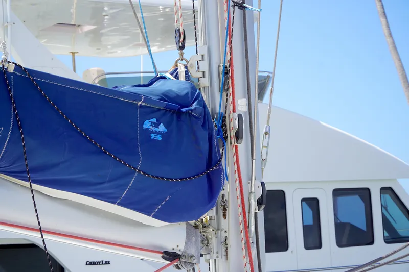 Red Yacht Photos Pics 2008 Fountaine Pajot Orana 44 sailboat with blue sail cover and rigging.