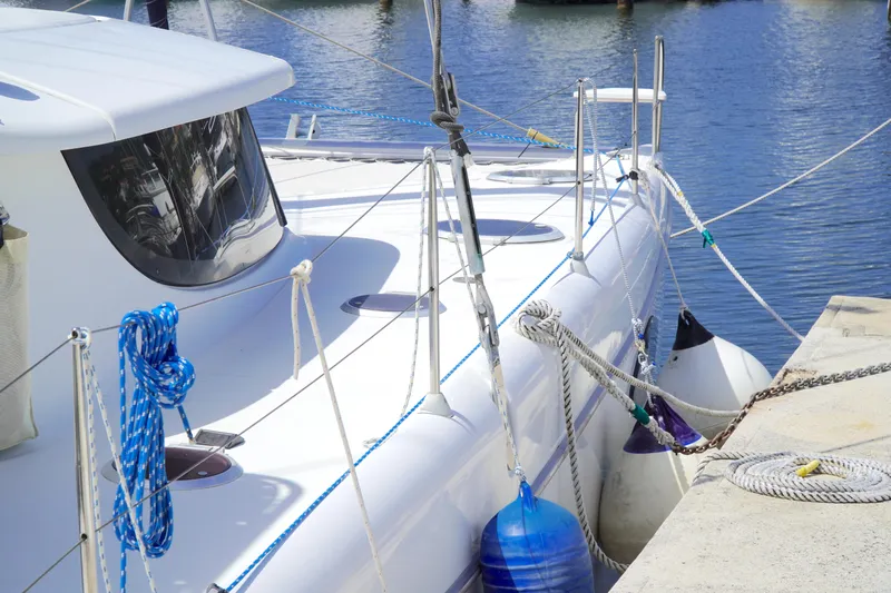 Red Yacht Photos Pics 2008 Fountaine Pajot Orana 44 catamaran docked, featuring ropes and fenders.