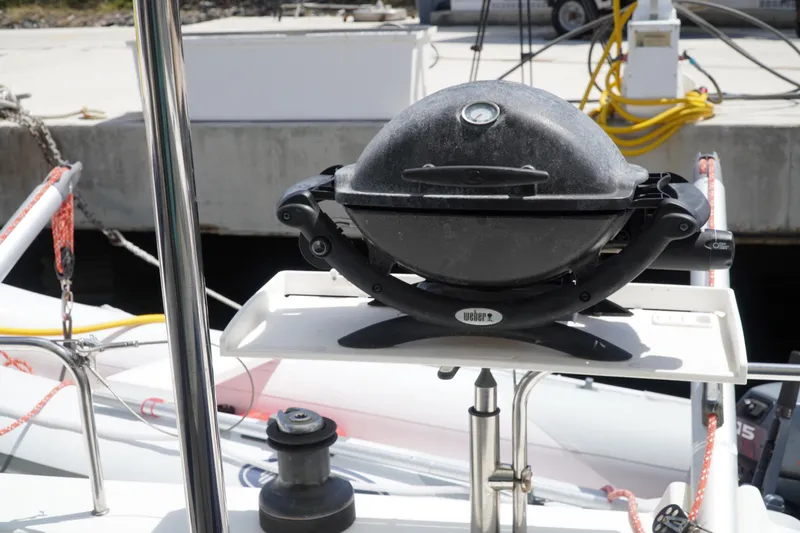 Red Yacht Photos Pics Outdoor grill on 2008 Fountaine Pajot Orana 44 catamaran deck, docked at marina.