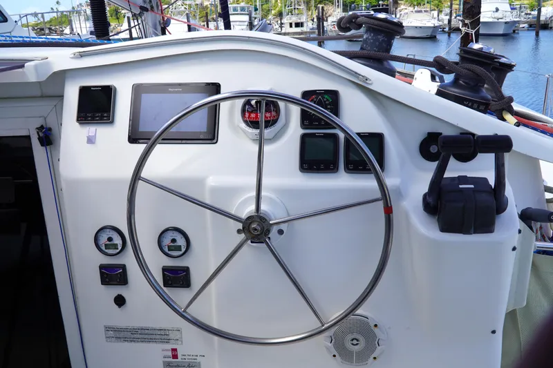 Red Yacht Photos Pics Helm of 2008 Fountaine Pajot Orana 44 catamaran with navigation instruments and steering wheel.