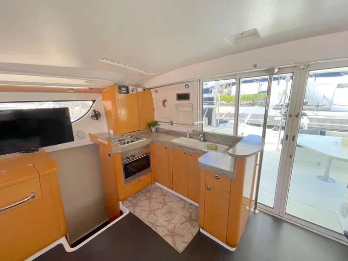 Red Yacht Photos Pics Spacious kitchen in 2008 Fountaine Pajot Orana 44 catamaran with modern amenities and outdoor view.