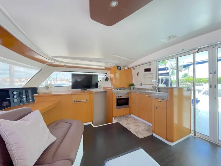 Red Yacht Photos Pics Luxurious interior of 2008 Fountaine Pajot Orana 44 catamaran with modern kitchen and seating area.