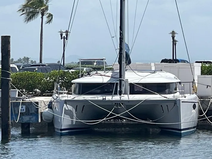 Red Yacht Photos Pics 2008 Fountaine Pajot Orana 44 catamaran docked at a marina with palm trees.