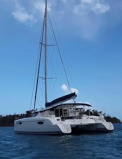 Red Yacht Photos Pics 2008 Fountaine Pajot Orana 44 catamaran sailing on calm waters under a clear blue sky.
