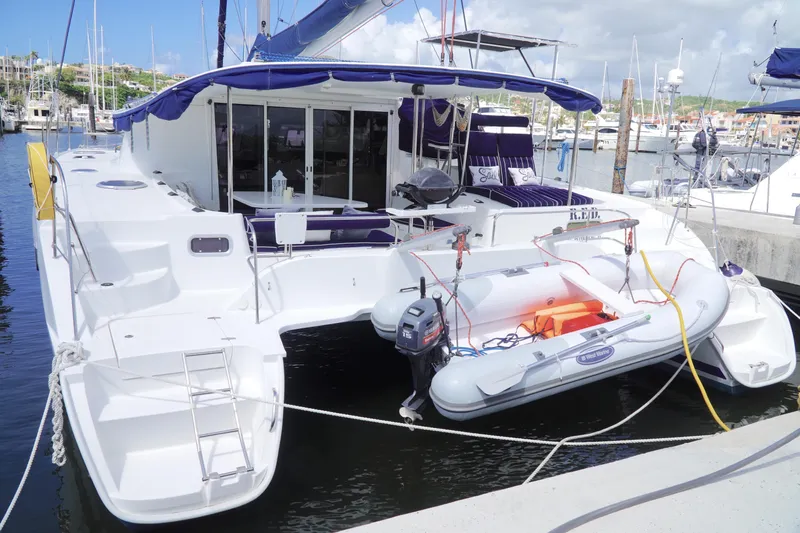 Red Yacht Photos Pics 2008 Fountaine Pajot Orana 44 catamaran docked with inflatable dinghy attached.