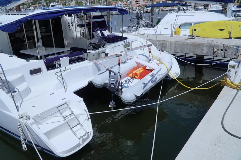 Red Yacht Photos Pics 2008 Fountaine Pajot Orana 44 catamaran docked with inflatable dinghy attached.