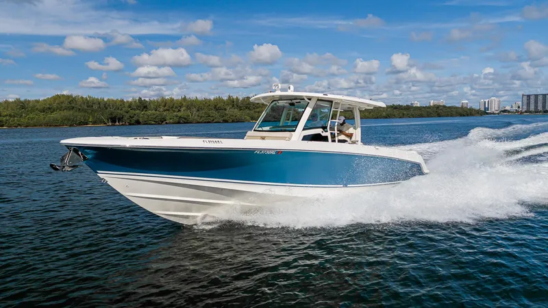  Yacht Photos Pics 2019 Boston Whaler 380 Outrage cruising on water under a clear blue sky.