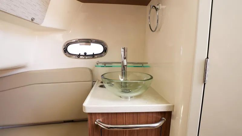  Yacht Photos Pics 2019 Boston Whaler 380 Outrage interior with modern sink and porthole window.