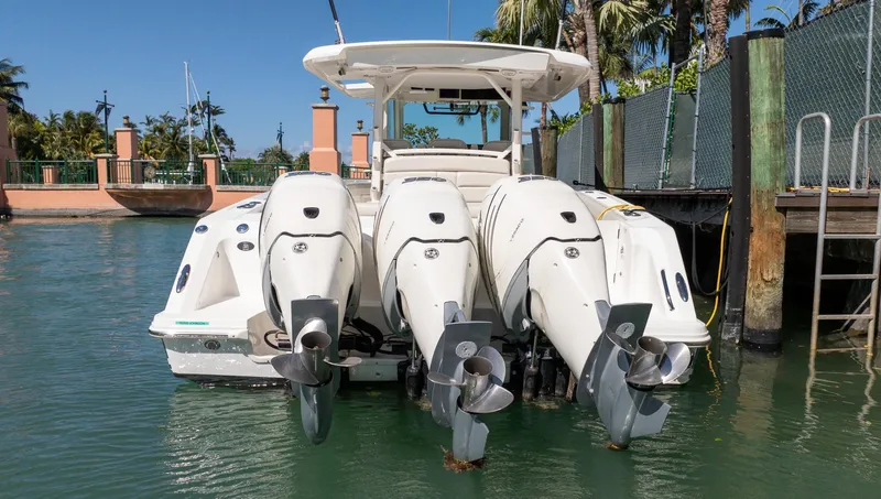  Yacht Photos Pics 2019 Boston Whaler 380 Outrage with four powerful outboard engines docked in marina.