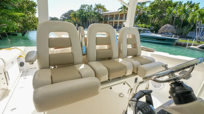  Yacht Photos Pics 2019 Boston Whaler 380 Outrage boat interior with plush seating and steering console.