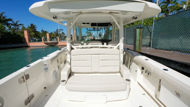  Yacht Photos Pics 2019 Boston Whaler 380 Outrage boat interior with seating, docked by water.