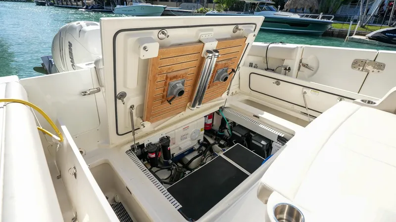  Yacht Photos Pics 2019 Boston Whaler 380 Outrage boat interior, showcasing open storage compartment and engine access.