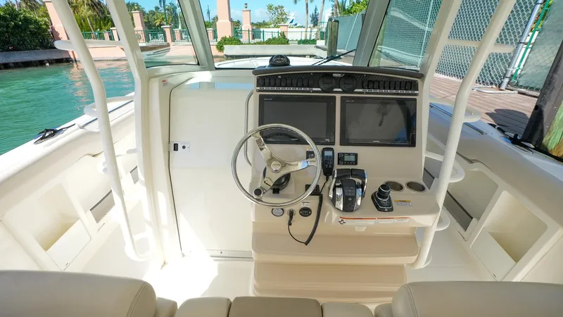  Yacht Photos Pics 2019 Boston Whaler 380 Outrage helm with dual screens and steering wheel.