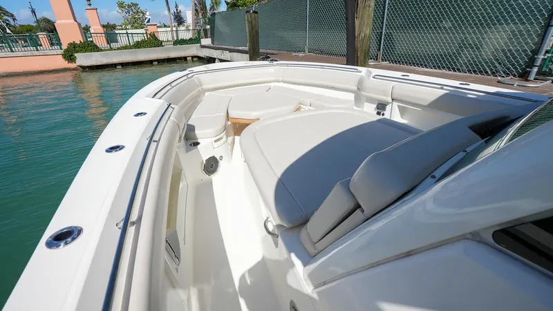  Yacht Photos Pics 2019 Boston Whaler 380 Outrage boat interior with cushioned seating by the water.
