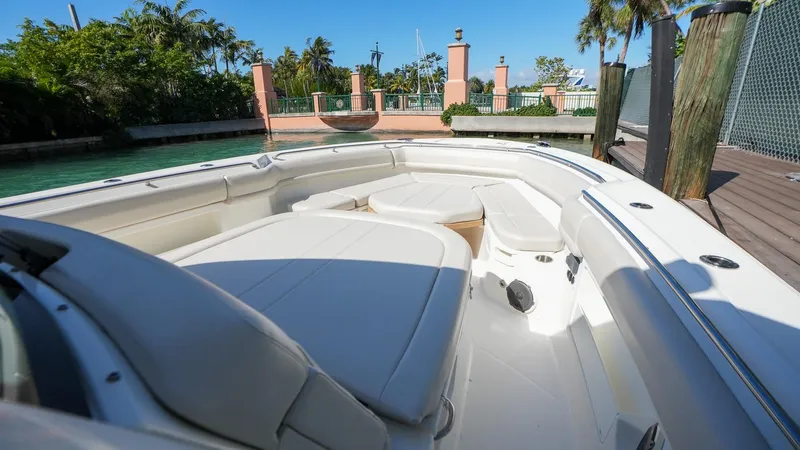  Yacht Photos Pics 2019 Boston Whaler 380 Outrage boat interior with seating, docked near tropical scenery.