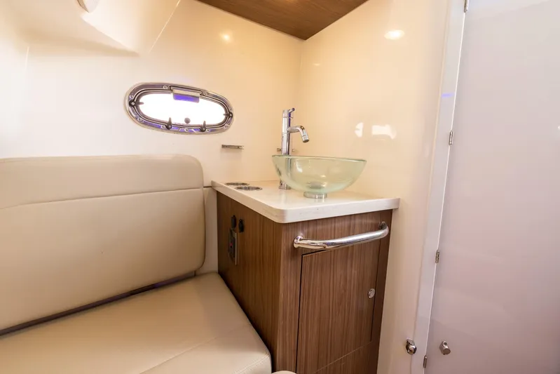  Yacht Photos Pics Interior of 2019 Boston Whaler 380 Outrage, featuring a modern sink and seating area.