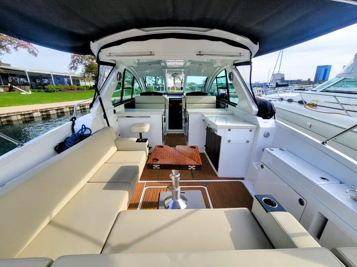  Yacht Photos Pics 2017 Monterey 360 Sport Coupe interior with seating, table, and marina view.