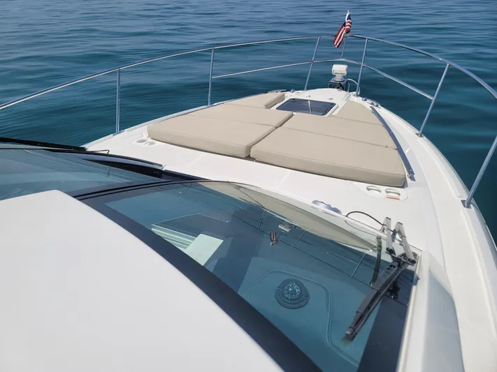  Yacht Photos Pics 2017 Monterey 360 Sport Coupe boat on calm water, featuring spacious deck and American flag.