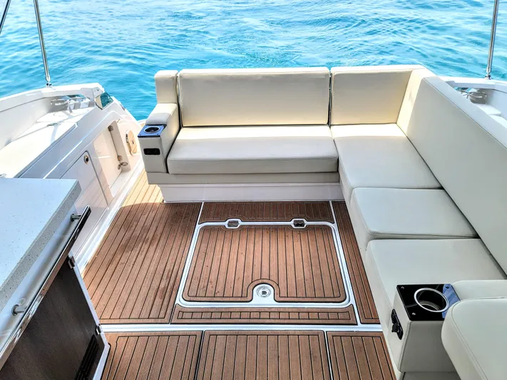 Yacht Photos Pics Luxurious seating area on a 2017 Monterey 360 Sport Coupe yacht with teak flooring.