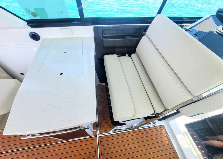  Yacht Photos Pics Luxurious seating and table on 2017 Monterey 360 Sport Coupe yacht interior.