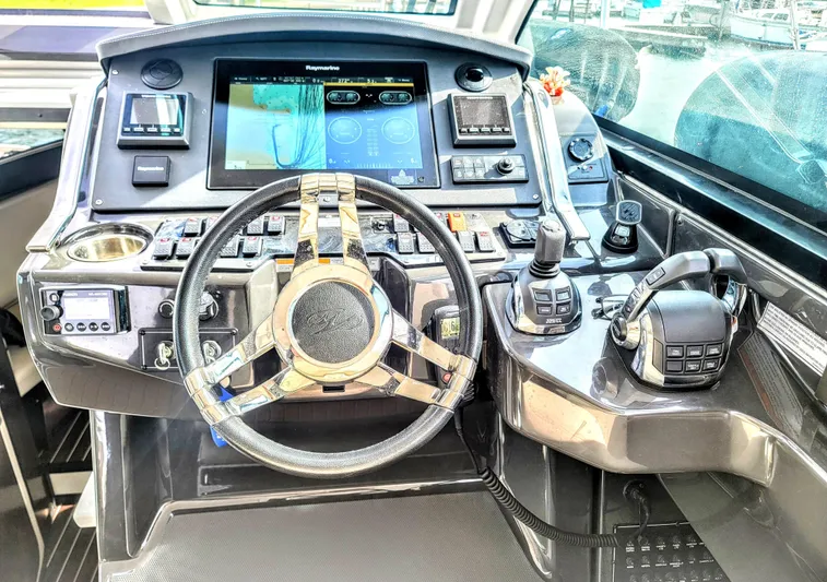  Yacht Photos Pics Cockpit of 2017 Monterey 360 Sport Coupe with advanced navigation controls and steering wheel.