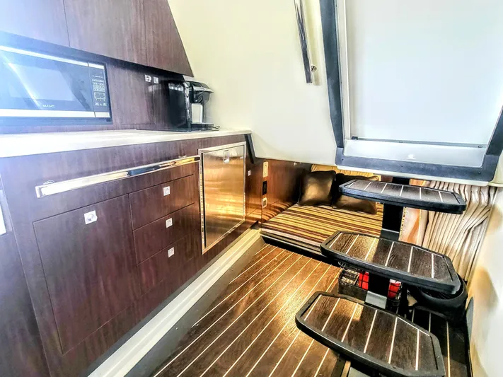  Yacht Photos Pics 2017 Monterey 360 Sport Coupe interior with modern kitchen and cozy seating area.