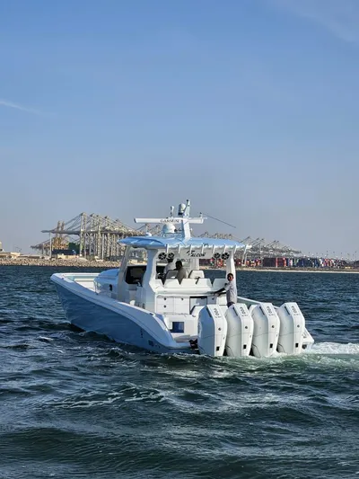  Yacht Photos Pics Custom FALCON 510 boat cruising near industrial port, 2025 model, clear blue sky.