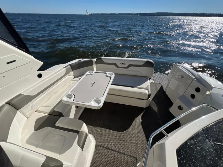  Yacht Photos Pics 2014 Monterey 320 Sport Yacht interior with seating and table, overlooking the ocean.