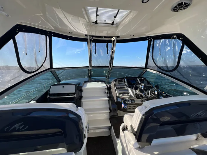  Yacht Photos Pics Interior view of 2014 Monterey 320 Sport Yacht cockpit with ocean backdrop.