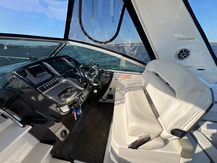  Yacht Photos Pics 2014 Monterey 320 Sport Yacht cockpit with modern controls and white seating.