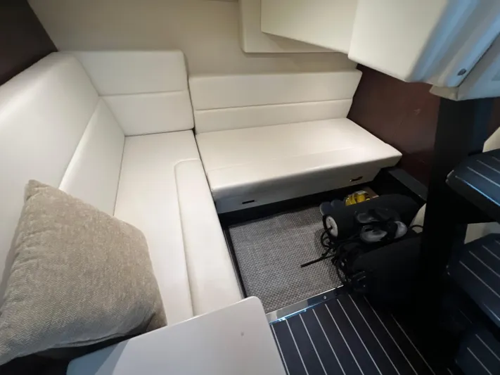  Yacht Photos Pics Interior of 2014 Monterey 320 Sport Yacht with white seating and a cushion.