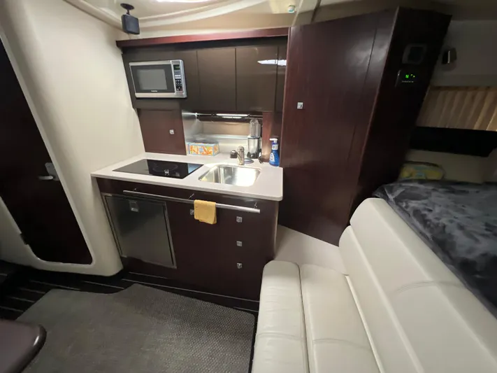  Yacht Photos Pics Interior of 2014 Monterey 320 Sport Yacht with kitchenette and seating area.