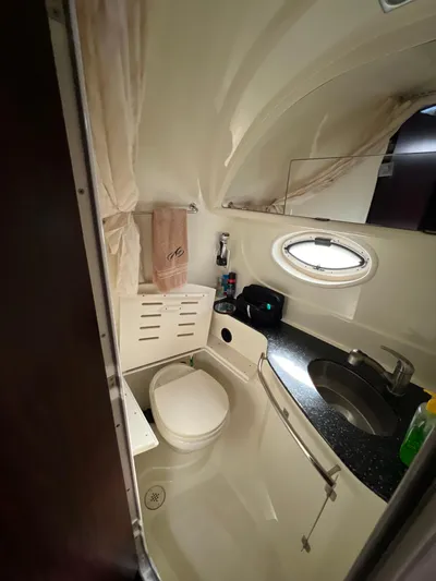  Yacht Photos Pics 2014 Monterey 320 Sport Yacht bathroom with sink, toilet, and porthole window.