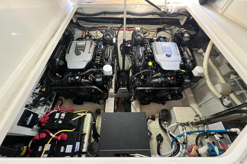  Yacht Photos Pics Engine compartment of a 2014 Monterey 320 Sport Yacht, featuring dual engines and battery setup.