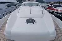 2005 Pershing 76 yacht with sleek design, docked in a marina with mountainous backdrop.