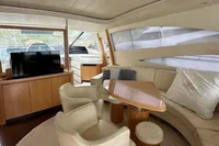 Luxurious interior of a 2005 Pershing 76 yacht with elegant seating and modern amenities.