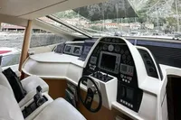 Cockpit of 2005 Pershing 76 yacht with advanced navigation controls and luxurious seating.