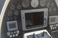 Control panel of a 2005 Pershing 76 yacht with gauges and navigation equipment.