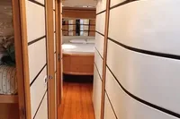 Luxurious interior hallway of a 2005 Pershing 76 yacht with modern design elements.