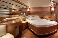 Luxurious bedroom interior on a 2005 Pershing 76 yacht, featuring elegant wood finishes.