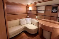 Luxurious interior of 2005 Pershing 76 yacht with elegant wood and cream furnishings.