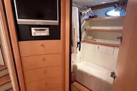 Interior of 2005 Pershing 76 yacht with TV, drawers, and closet space.