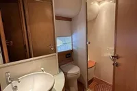 Luxurious bathroom in 2005 Pershing 76 yacht with modern fixtures and elegant design.